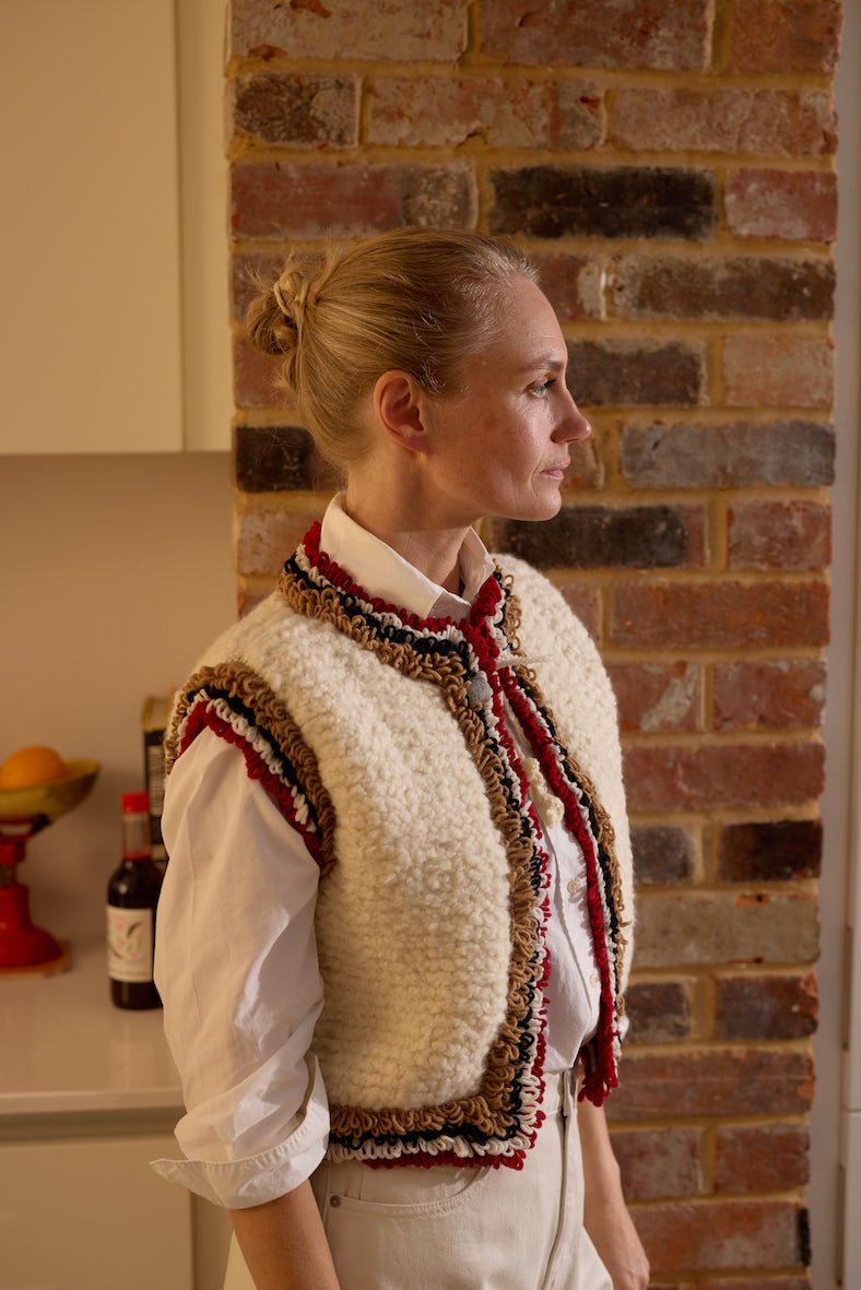 Cream Mountain Vest layered over white shirt modern Alpine knitwear