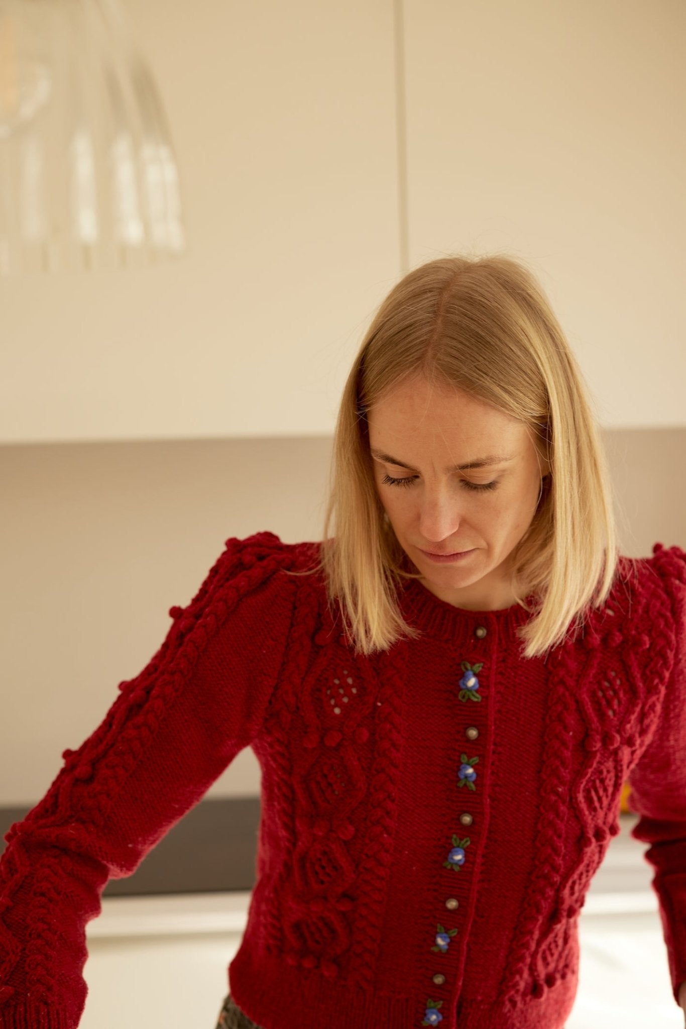 handknitted deep red merino wool cardigan with embroidered placket